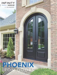 Elegant black arched iron double doors on a brick home with glass panels and surrounding greenery.