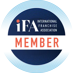International Franchise Association Member logo with bold letters and circular design elements.