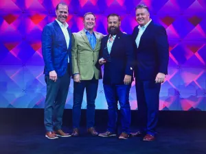 Roof It Forward Leadership Team accepting the 2022 Owens Corning Top Performer MVP Award at the 2022 Owens Corning Roofing Platinum Awards.