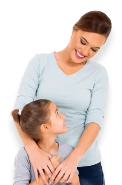 Smiling mother in blue shirt hugging and looking lovingly at her daughter with ponytail and gray shirt.