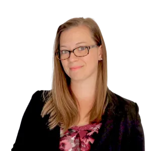 Professional woman with glasses, long straight hair, floral blouse, and black blazer smiling confidently