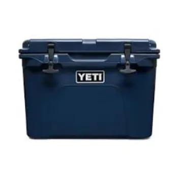 Dark blue YETI cooler with secure latches and logo on front, designed for outdoor use and ice retention.
