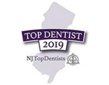 NJ Top Dentist 2019 badge featuring New Jersey state silhouette and award text in purple and black.