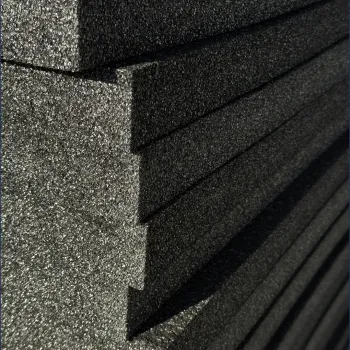 Stacked dark gray acoustic foam panels with textured, porous surface and angled edges for sound absorption.