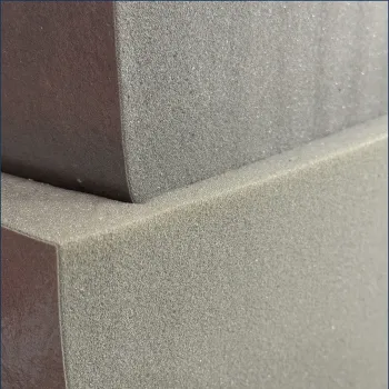 Close-up of stacked gray foam blocks showing texture and sharp edges in soft light