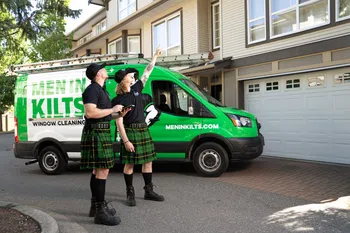a group of people in kilts standing in front of a green van