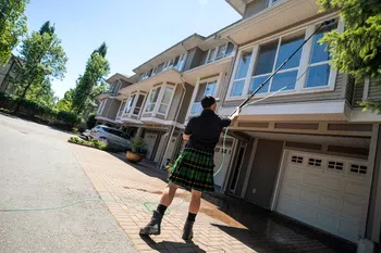 a person in a kilt washing a window