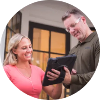 a man and woman looking at a tablet