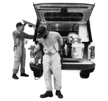 Two workers in uniforms standing by the open back of a work truck with equipment and supplies