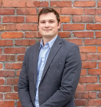 a man in a suit smiling