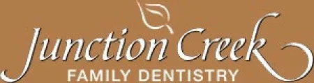 Junction Creek Family Dentistry logo with white text and a leaf design on a brown background