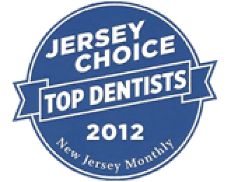 Blue circular badge with white text reading Jersey Choice Top Dentists 2012 New Jersey Monthly.