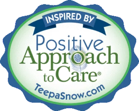 Seal featuring text Inspired by Positive Approach to Care with a peacock feather and website TeepaSnow.com