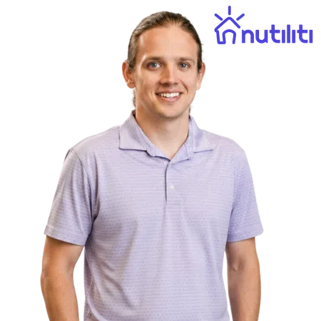 Smiling man wearing a light purple polo shirt standing against a plain background with Nutiliti logo in blue.