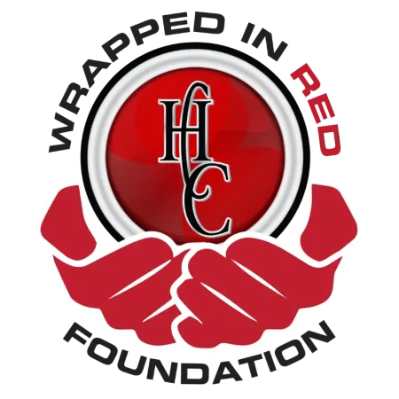 Red hands holding a red circle with HHC initials, surrounded by the words Wrapped in Red Foundation.