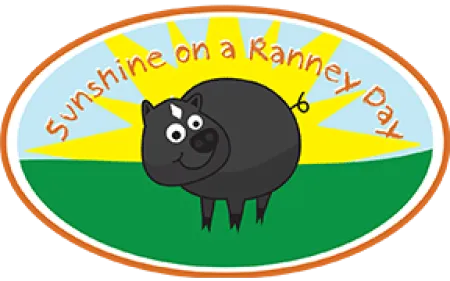 Cartoon black pig standing on green grass with sun rays and text Sunshine on a Ranney Day above.