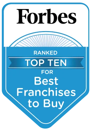 Forbes badge ranked top ten best franchises to buy with blue and white design and bold text.