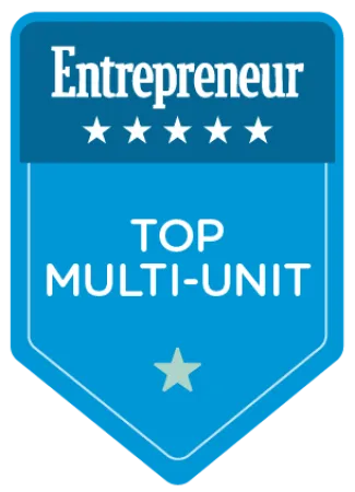 Entrepreneur badge with five stars and text Top Multi-Unit on blue shield background