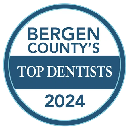 Bergen County's Top Dentists 2024 award badge with blue and white circular design.