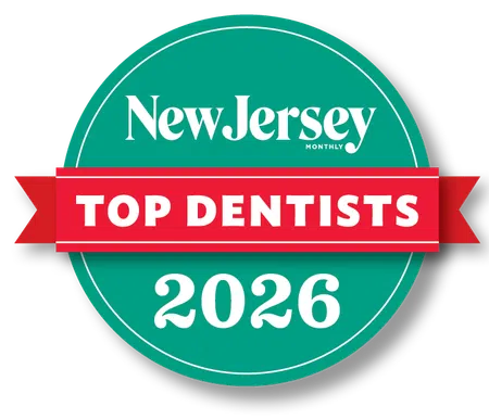 New Jersey Monthly Top Dentists 2026 badge with green circle and red banner. 