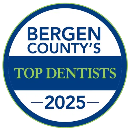 Bergen County's Top Dentists 2025 badge in blue, white, and green circular design.