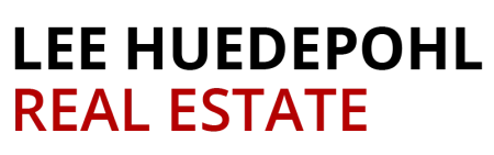 Real estate text in bold red and black with a house roof silhouette icon above the words.
