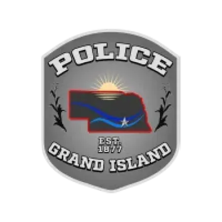 Grand Island Police badge with Nebraska map, sun rising, and blue river graphic on gray shield.