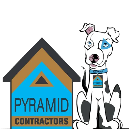 White dog with black spots wearing a Pyramid Contractors tag sitting next to a blue and brown Pyramid Contractors logo.