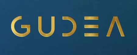 Gold stylized letters spelling GUDEA on a dark blue background with unique geometric shapes.