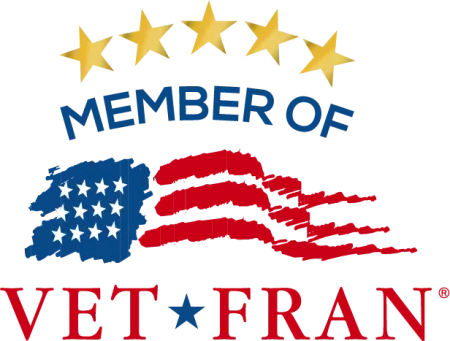 VetFran member logo featuring five stars above an American flag design and bold red and blue text.