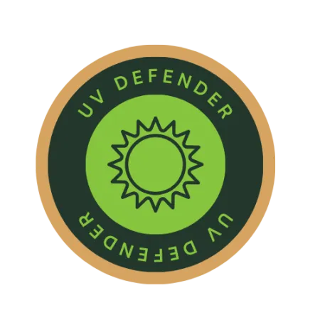 Round UV Defender badge with sun icon in green and black colors and a gold outer ring.