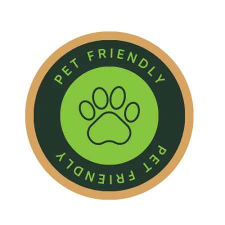 Round pet friendly badge with a green paw print in the center and text on a dark green background