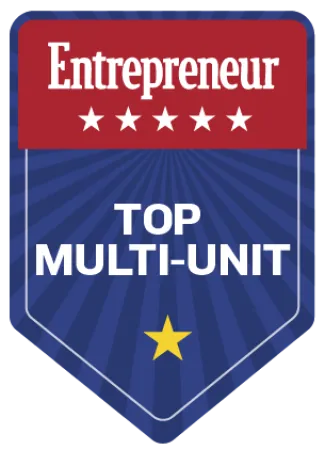 Entrepreneur Top Multi-Unit award badge with stars on red and blue background.