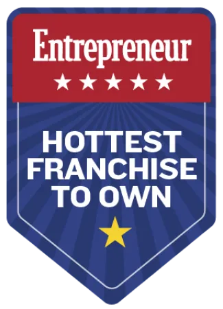 Entrepreneur badge designating hottest franchise to own with stars and bold text on blue and red background.