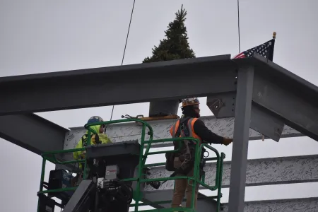 a few men working on a roof