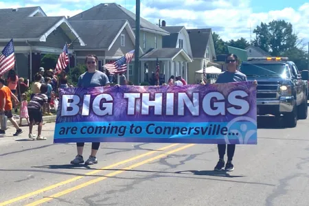 a group of people marching with a large banner