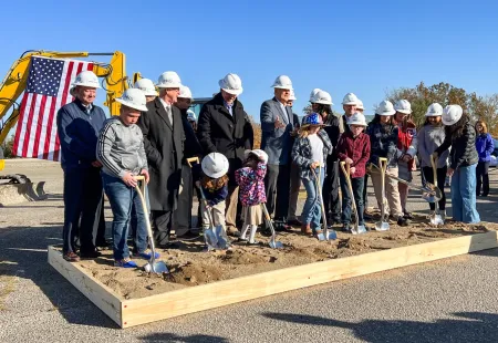 a group of people wearing hardhats and standing on a construction site