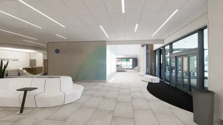 a room with white couches and a green wall