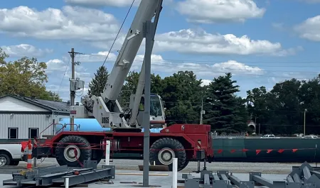a large crane lifting a large piece of metal