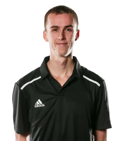 Young man wearing a black Adidas polo shirt smiling standing against a transparent background