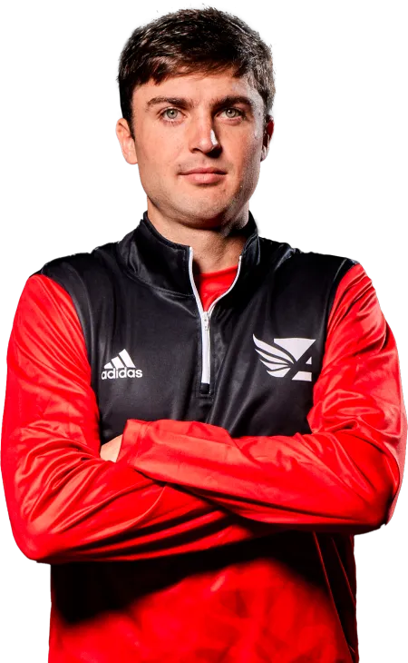 a man wearing a red and black jacket with his arms crossed