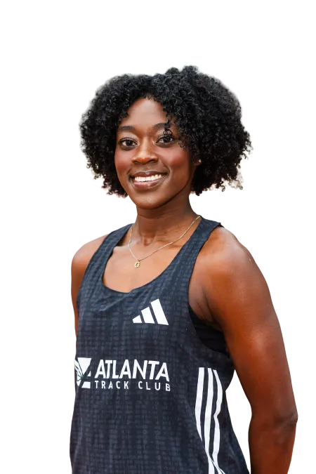 Smiling female athlete with curly hair wearing Atlanta Track Club black tank top with Adidas logo
