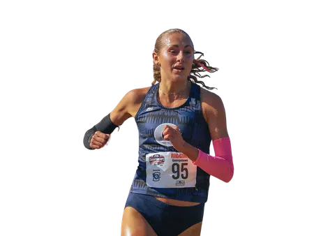 Female athlete running in a race wearing navy blue sportswear and race bib number 95 with arm sleeves.