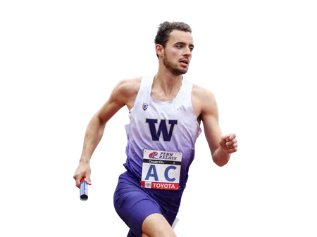 Male relay runner in purple and white uniform holding baton during a race with focused expression