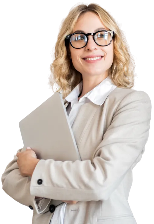 Smiling blonde woman in glasses and beige suit holding a laptop confidently with arms crossed