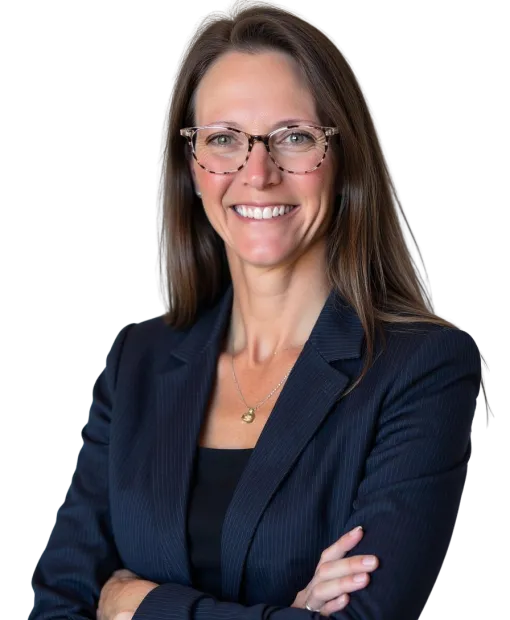 Confident professional woman wearing glasses and a navy pinstripe blazer smiling with arms crossed.