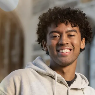 Young Man in Gray Sweater Smiling