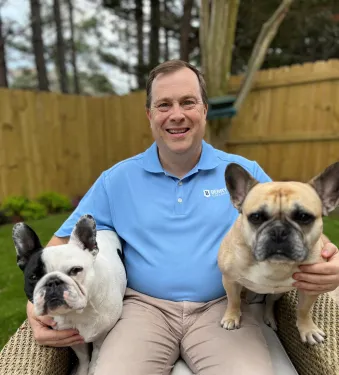 a person holding two dogs