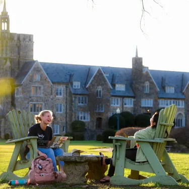 a person sitting on a bench in front of a building