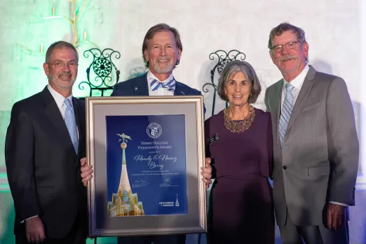 a group of people holding a framed picture